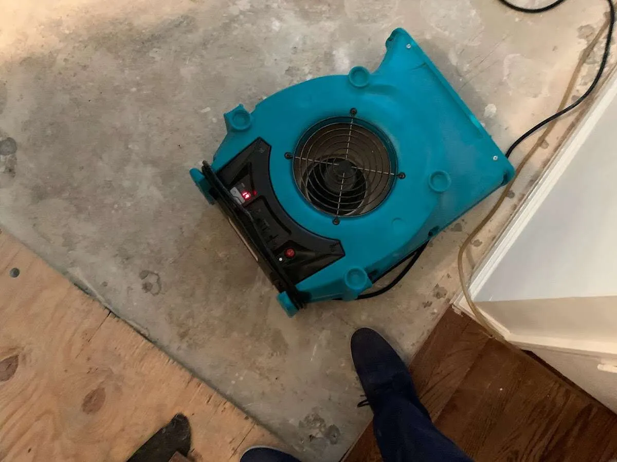 Air mover drying subfloor during Commercial Water Damage Restoration in Sayre